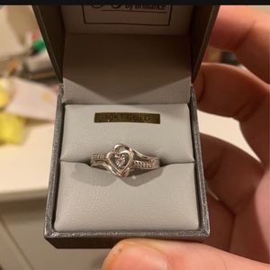 Diamond sterling silver ring with a heart in the middle.